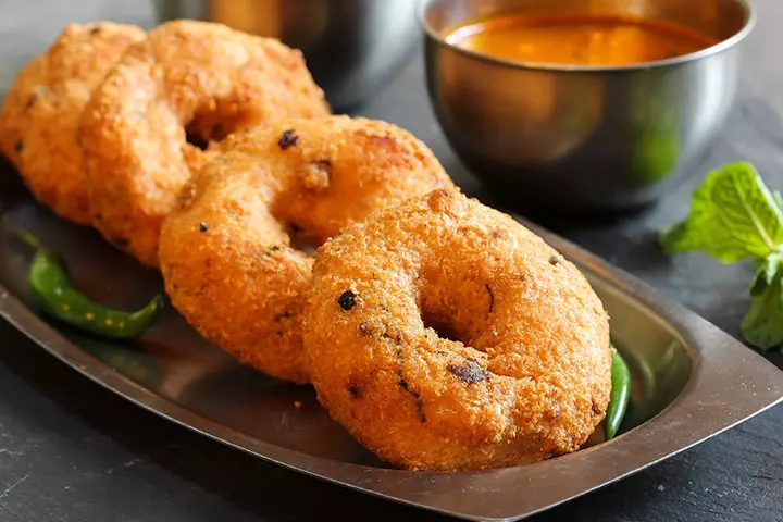Medu Vada - Deep-fried lentil doughnuts made from urad dal. Why it’s healthy (in moderation): High in protein and iron. Best enjoyed with: Coconut chutney and hot sambar.