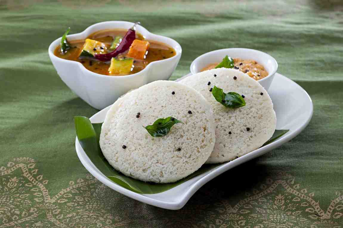 Idli - A staple across South India, idlis are steamed rice cakes made from fermented rice and urad dal batter. Why it’s healthy: Fermented, low in fat, and easy to digest. Best served with: Coconut chutney & piping hot sambar.